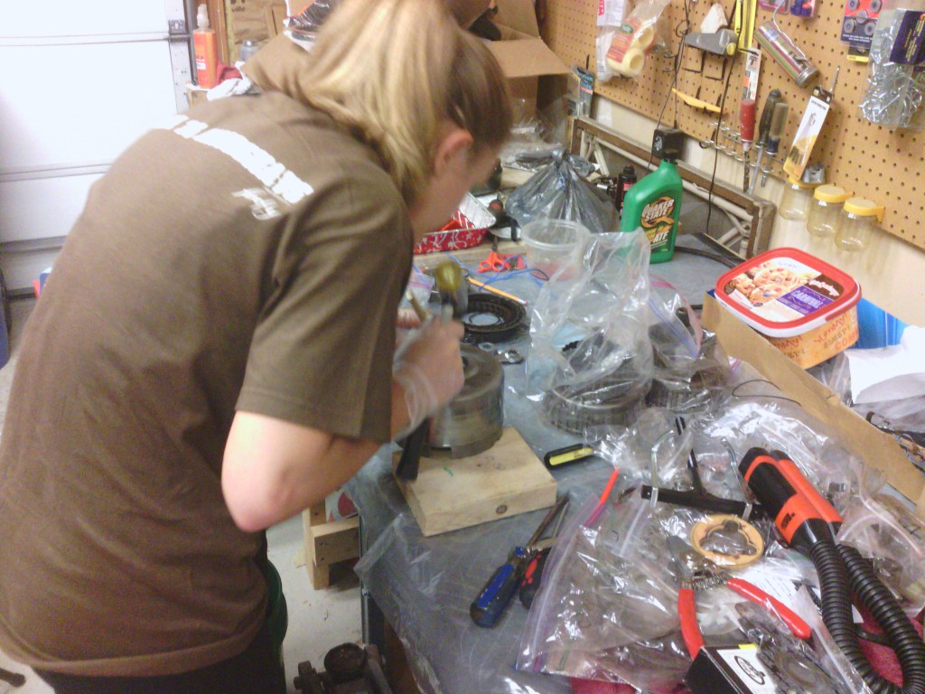 Jackie rebuilding the direct clutch.  Here she is driving out one of the bushing with a brass drift punch, getting ready for new bearings.