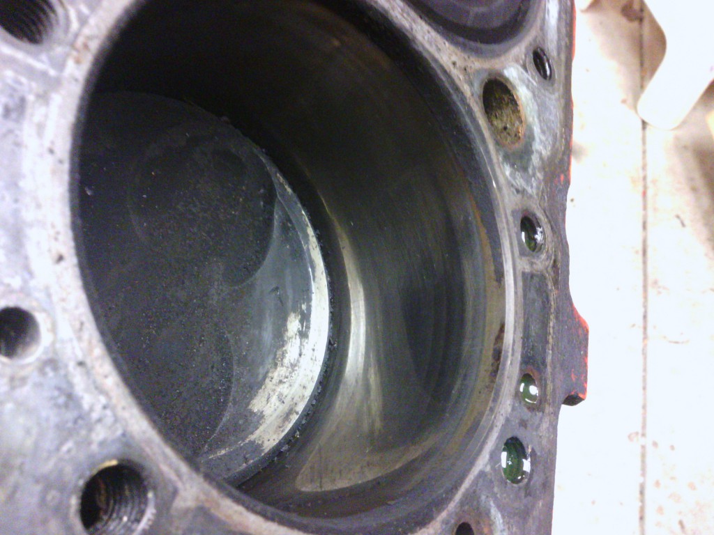 The cylinder bores are in excellent shape with no ridge-wear evident.  The edge shown in the picture is simply the boundary between the section of the bore that was polished by the rings, and the original finish.  A "fingernail test" showed no edge in the metal.  This is great news since if the other cylinders check out, this engine will not need a re-bore.